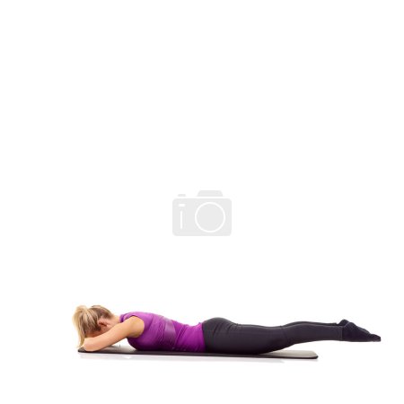 Photo for Yoga mat, health and fitness with woman in studio for stretching, exercise and wellness. Workout, relax and self care with female person on floor of white background for pilates, body or mockup space. - Royalty Free Image