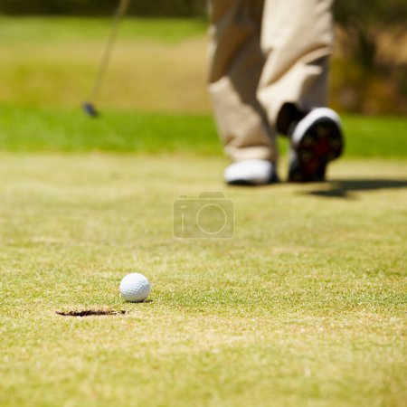 Photo for Golf, ball and hole on a green in summer for sports, recreation or leisure closeup for hobby. Grass, ground or field with a golfer walking on a course during a game of competition or training. - Royalty Free Image