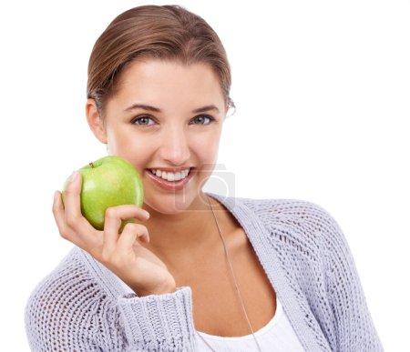 Photo for Woman, portrait and apple, nutrition and gut health with snack, happy with diet for weight loss on white background. Healthy food, wellness and green fruit, vegan and organic with smile in studio. - Royalty Free Image