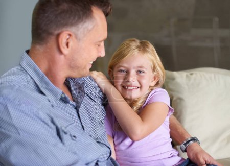 Photo for Father, girl and hug in portrait, support and happiness or love in childhood by single parent at home. Daughter, daddy and together in embrace, trust and bonding or security and connection on couch. - Royalty Free Image