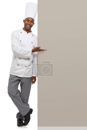 Photo for Poster, portrait and black man chef with hand pointing to studio for checklist, menu or space on white background. Bakery, presentation or baker face with food tips billboard, guide or steps mock up. - Royalty Free Image