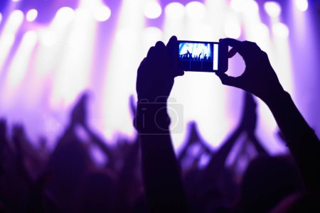 Photo for Nightclub, concert and audience with phone or lights for music, party and rave festival with silhouette and dancing. Disco, psychedelic event or performance with entertainment, crowd and smartphone. - Royalty Free Image