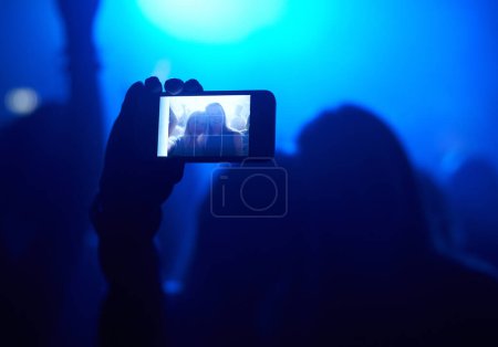 Photo for Nightclub, festival and audience with selfie or lights for music, party and rave concert with silhouette and memory. Disco, psychedelic event and performance with entertainment, crowd and smartphone. - Royalty Free Image