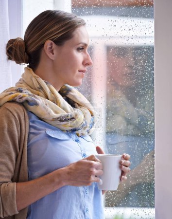 Photo for Woman at window, thinking with tea and reflection, life and future in morning routine, raindrop and wellness. Insight, memory and mindfulness with warm beverage, coffee break and relax at home. - Royalty Free Image