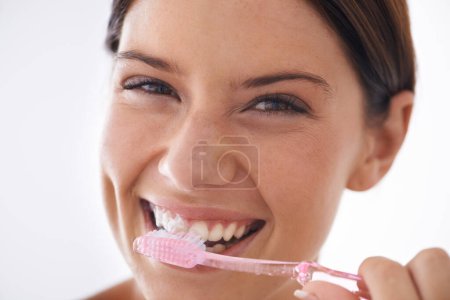 Foto de Cepillo de dientes, feliz y retrato de mujer sobre fondo blanco para el cuidado dental, higiene bucal o limpieza. Cuidado de la salud, blanqueamiento y la cara de la persona cepillarse los dientes con pasta de dientes para el bienestar en el estudio. - Imagen libre de derechos