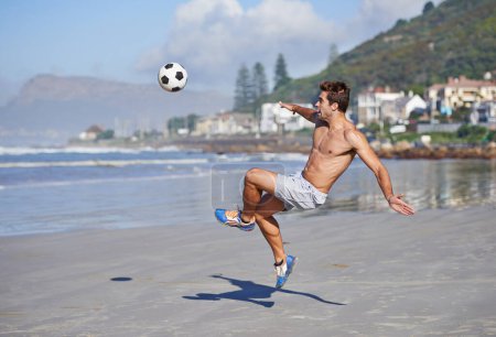 Photo for Man, beach and volley with soccer ball for game, sports or exercise in outdoor hobby, training or practice. Young male person or football player kicking in match or cardio workout by ocean coast. - Royalty Free Image