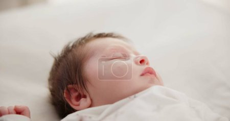 Photo for Baby, face and sleeping in the morning on nursery bed and blanket with nap and rest. Relax, calm and tired newborn with youth on bedding with kid sleeping from above in a family home and bedroom. - Royalty Free Image