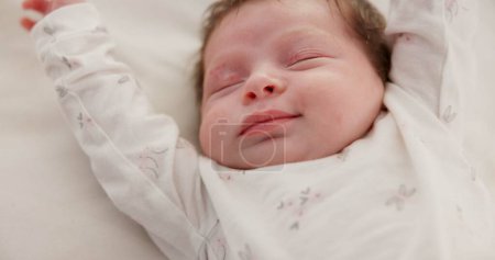 Photo for Baby, sleeping stretch and nursery bed with morning, nap and dreaming of a young newborn at home. Cozy, sleepy kid and calm with health development from rest and peace in house with closeup and care. - Royalty Free Image
