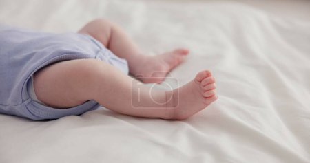 Photo for Adorable, family and feet of baby on bed for child care, relax and resting in nursery. Innocent, cute and closeup of toes of innocent newborn infant for health, wellness and development at home. - Royalty Free Image