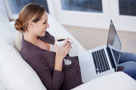 Photo for Relax, laptop and happy woman on a sofa with coffee while streaming movie, film or video at home. Pc, internet or female person in a living room with tea, break or social media, subscription or show. - Royalty Free Image