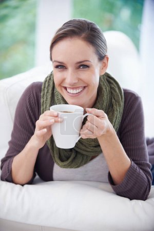 Photo for Coffee, happy and portrait of woman in home with calm, wellness and peace on sofa in living room. Morning, breakfast and person with mug relax and drinking tea, caffeine and hot beverage in house. - Royalty Free Image