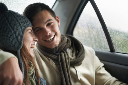 Photo for Love, raining and couple in car for road trip together, laughing on date for travel, vacation or romance. Smile, winter or weather with man and woman in backseat of taxi for holiday trip or journey. - Royalty Free Image