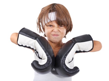 Photo for Boxing, gloves and portrait of child in fight with anger and learning martial arts in white background. Challenge, boxer or kid with training in self defense, exercise or practice with gear in studio. - Royalty Free Image