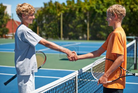 Photo for Players, tennis and handshake with game, winner and court with friends, athlete or fitness. Boys, outdoor or teenagers shaking hands or competition with exercise or tournament with training or sports. - Royalty Free Image
