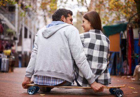 Photo for Couple, travel on skateboard and outdoor in city, happy and conversation with partner, learn together and relationship. Cape town, fun and hobby with boyfriend and girlfriend in street, love or date. - Royalty Free Image