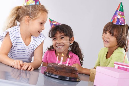 Photo for Friends, children and birthday cake, party and candles with happy people for celebration, youth and dessert. Special day, together in festive mood and kids smile for social event with chocolate. - Royalty Free Image