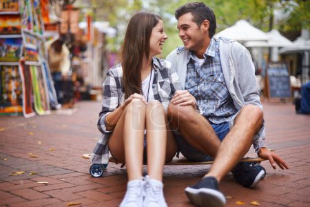 Photo for Couple, travel on skateboard and happy in city, outdoor and conversation with partner, learn together and relationship. Cape town, fun and hobby with boyfriend and girlfriend in street, love or date. - Royalty Free Image