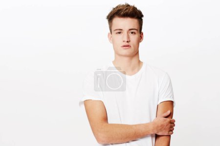 Photo for Portrait, fashion and relax with casual man in studio isolated on white background for classic style. Model, clothes and serious with confident young person in t-shirt or clothing outfit on mockup. - Royalty Free Image
