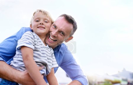 Photo for Father, son and portrait with hug outdoor for bonding, holiday or vacation memories with blue sky. Family, man and boy child with embrace for relationship, love or care in nature with smile or mockup. - Royalty Free Image