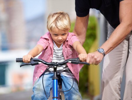 Photo for Father, bike and teaching child to ride in outdoor, bonding together and wellness with childhood development. Parent, son and fun in nature for learning bicycle, love and care for cycling on vacation. - Royalty Free Image