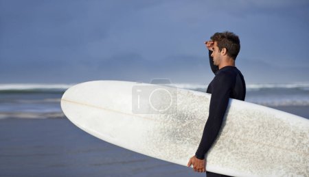 Photo for Looking, surfing and man with surfboard at beach for, waves on summer vacation, weekend and holiday by sea. Travel, nature and person by ocean for water sports, adventure and hobby in Australia. - Royalty Free Image