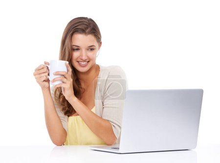 Photo for Laptop, coffee or happy woman in studio for streaming on social media, blog or copywriting research. Freelancer, smile or female person editing online isolated on a white background on break to relax. - Royalty Free Image