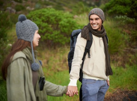 Photo for Woods, hiking and happy couple holding hands on mountain and travel with backpack, nature and bonding. Outdoor, adventure and trekking in path, forest and winter for travelling and explore together. - Royalty Free Image
