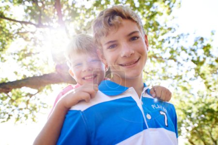 Photo for Piggy back, portrait and boys in a forest, summer and vacation with happiness or bonding together. Fresh air, face or young people in a park or relax with a game and sunshine with lens flare or smile. - Royalty Free Image
