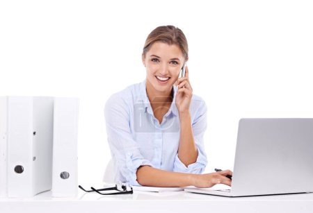 Photo for Laptop, phone call and portrait of woman in studio for appointment information at secretary desk. Communication, smile and female receptionist on mobile conversation with computer by white background. - Royalty Free Image