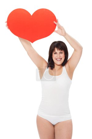 Photo for Portrait, heart and happy plus size woman in studio isolated on a white background. Love, sign or symbol of model in underwear with healthy body for care, kindness emoji and romance on valentines day. - Royalty Free Image