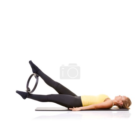 Photo for Pilates ring, legs and woman training in studio isolated on a white background mockup space. Exercise, person on mat and yoga circle for feet, balance and fitness for healthy body workout on floor. - Royalty Free Image