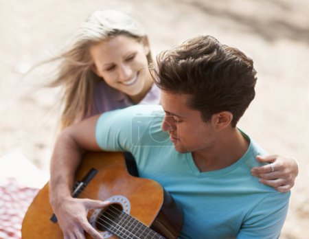 Photo for Couple, picnic and playing guitar for romance, love or song in outdoor bonding, fun or relaxing together in nature. Man and woman smile with instrument for acoustic sound, strumming or music outside. - Royalty Free Image