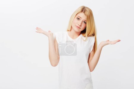 Photo for Space, confused or woman in portrait unsure, doubt or wondering isolated on white background. Person asking, dont know hand gesture or puzzled model with decision, choice or question on studio mockup. - Royalty Free Image
