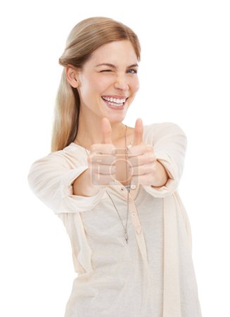 Photo for Portrait, wink and happy woman with thumbs up in studio for support, trust or winning gesture on white background. Face, smile and female model with hand emoji for success, thank you or motivation. - Royalty Free Image