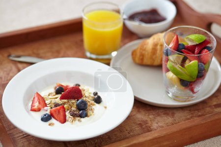 Photo for Food, wellness and closeup of breakfast tray with muesli for balance, benefits or gut health. Fruit, zoom and croissant with vitamins for diet, nutrition or healthy eating, brunch or superfoods salad. - Royalty Free Image