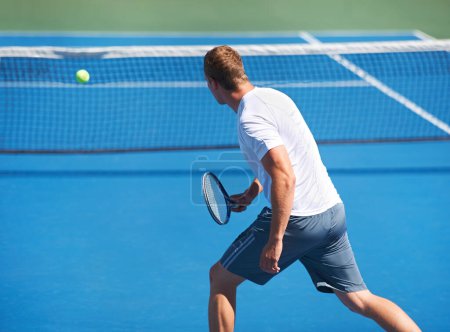 Photo for Sport, man and tennis on court with fitness, competition and performance outdoor with serve and energy. Athlete, player and ball on turf for training, exercise and racket with skill, game or wellness. - Royalty Free Image