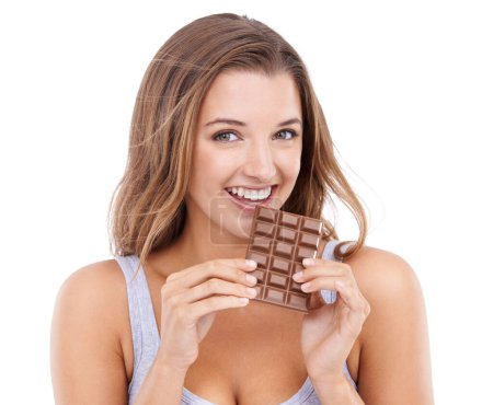 Photo for Happy woman, eat chocolate and portrait with candy, sweet tooth and pleasure for craving sugar in studio background. Happy, snack and meal for comfort, dessert or sweets for calories, diet or tempt. - Royalty Free Image