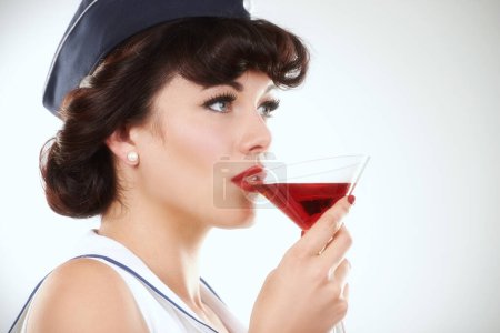 Photo for Glass, stewardess and woman drink alcohol in studio isolated on a white background mockup space. Martini cocktail and an air hostess, vintage pin up girl model or flight attendant travel on journey. - Royalty Free Image