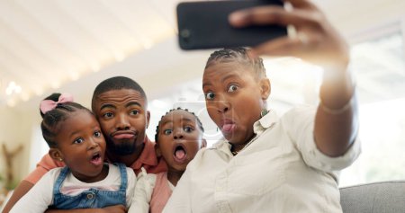 Photo for Black family, selfie and funny face, parents and kids at home, fun and bonding with memory for social media. Live streaming, playful and portrait, people with goofy expression in picture for post. - Royalty Free Image