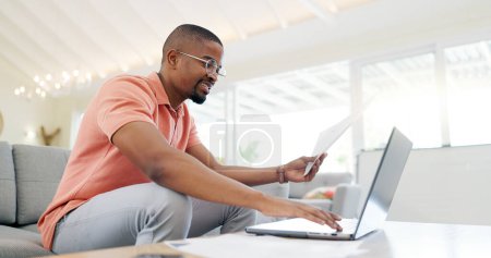 Photo for Happy, typing and a black man with a phone on the sofa for social media, connection or communication. Smile, relax and an African person with a mobile for an app, email or notification in a house. - Royalty Free Image