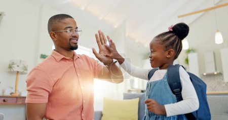 Photo for Black family, education and girl with backpack for school, kindergarten and high five from dad for support and motivation. Child, student and father helping to get ready and leave house in morning. - Royalty Free Image