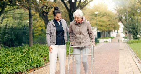 Photo for Senior woman, walker and nurse outdoor in a park with healthcare for elderly exercise. Walking, healthcare professional and female person with peace and physical therapy in a public garden with carer. - Royalty Free Image