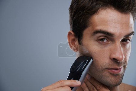 Photo for Man, portrait and electric razor for shaving beard or maintenance, hair removal or grey background. Male person, shirtless and tools for cleaning skin or hygiene car for confidence, studio or mockup. - Royalty Free Image