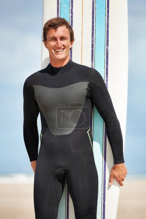 Photo for Beach, portrait or happy man with surfboard for exercise, fitness for body health or summer outdoor. Surfer, wetsuit or smile of person by ocean for water sports, travel or holiday vacation in Hawaii. - Royalty Free Image
