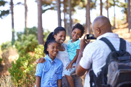 Photo for Happy black family, photographer and nature for hiking, bonding or outdoor together for photo. African mother, children and father smile taking picture on phone for photography or adventure in nature. - Royalty Free Image