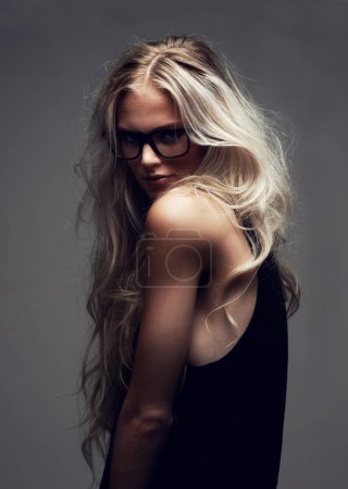 Photo for Portrait, woman and glasses in studio with fashion, style and trendy aesthetic with positive by gray background. Model, pride and eyecare on face with attitude, blonde and cool in sunglasses. - Royalty Free Image