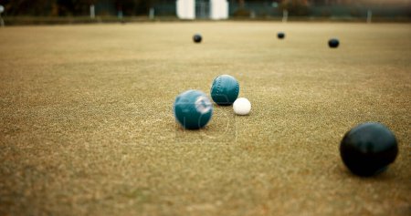 Photo for Green, balls and lawn bowling game on grass, field or pitch in a match or competition of outdoor bowls. Ball, moving and sport tournament at a bowlers club, league or championship games on the ground. - Royalty Free Image