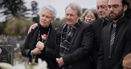 Photo for Death, funeral and elderly couple sad together at pain or grief for death and loss during a ceremony. Rose, support or empathy with a senior man and woman feeling depression at a memorial service. - Royalty Free Image