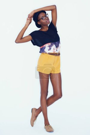 Photo for Portrait, fashion and glasses with trendy black woman in studio on white background for hipster style. Model, clothes or accessories with confident and tall young person in shorts for clothing outfit. - Royalty Free Image