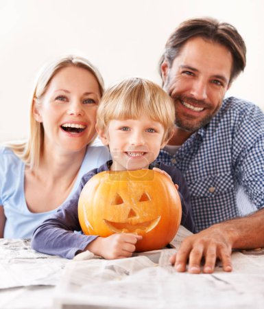 Photo for Portrait, parents and kid with pumpkin for halloween to celebrate with fun together. Happy family, mom and dad with boy child carving face in vegetable for holiday lantern, decoration and party. - Royalty Free Image